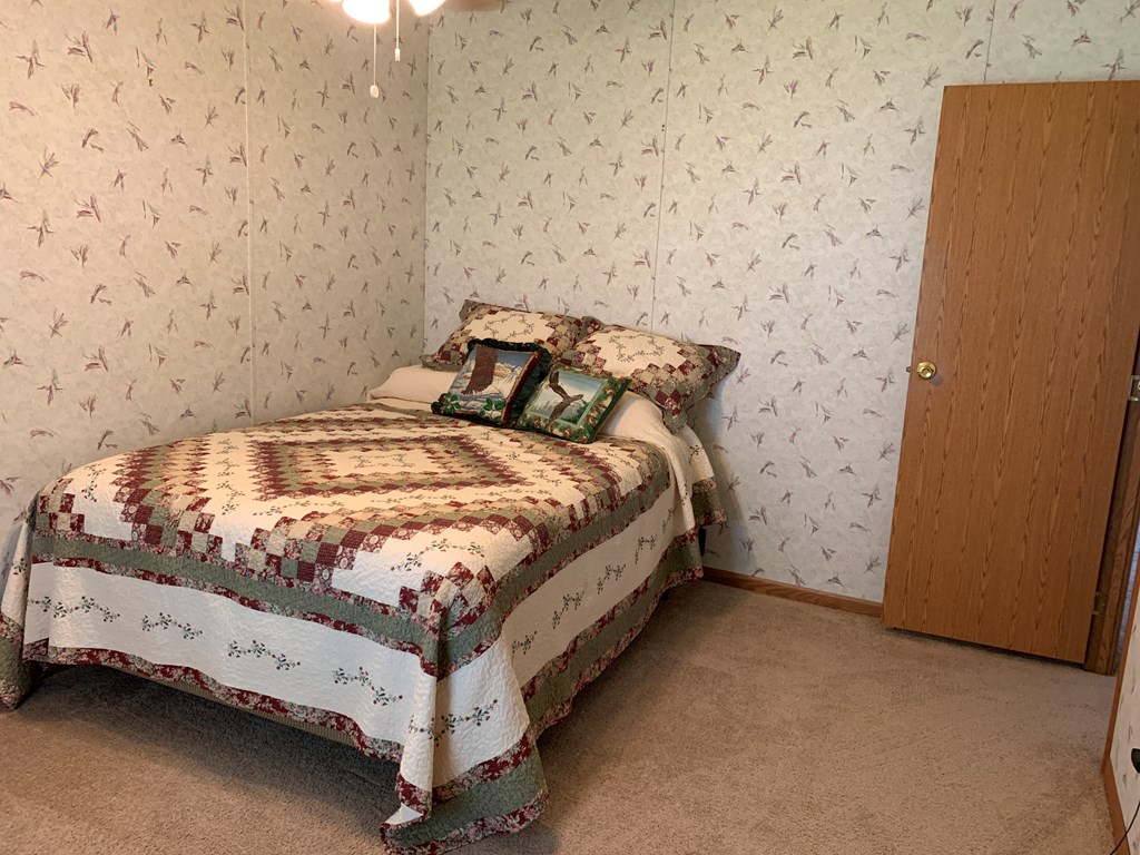 3870 Georgetown Road Polk, PA 16342 - Photo 36 of 42 a bedroom with a bed and a wall painting