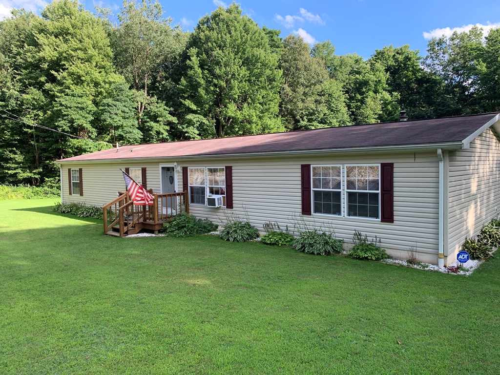 3870 Georgetown Road Polk, PA 16342 - Photo 4 of 42 a view of a house with a yard and a garden