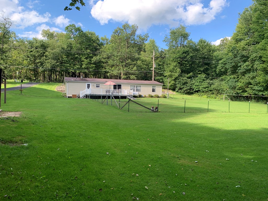 3870 Georgetown Road Polk, PA 16342 - Photo 6 of 42 a backyard of a house with table and chairs