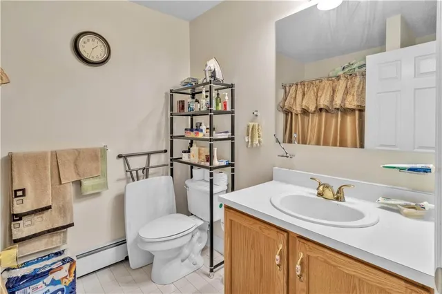 a bathroom with a sink a toilet and shower curtain