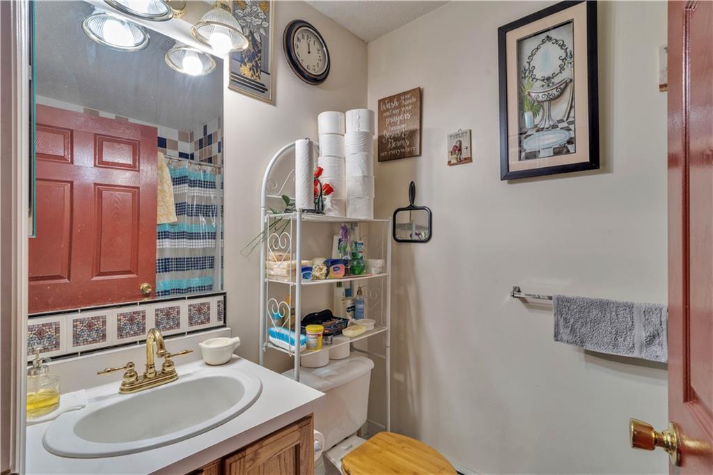 221 MacDougal Street Brooklyn, NY 11233 - Photo 17 of 23 a bathroom with a sink mirror and vanity