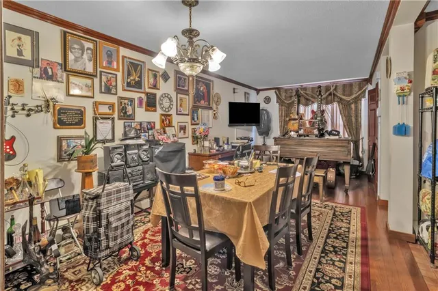 a view of a dining room with furniture and chandelier