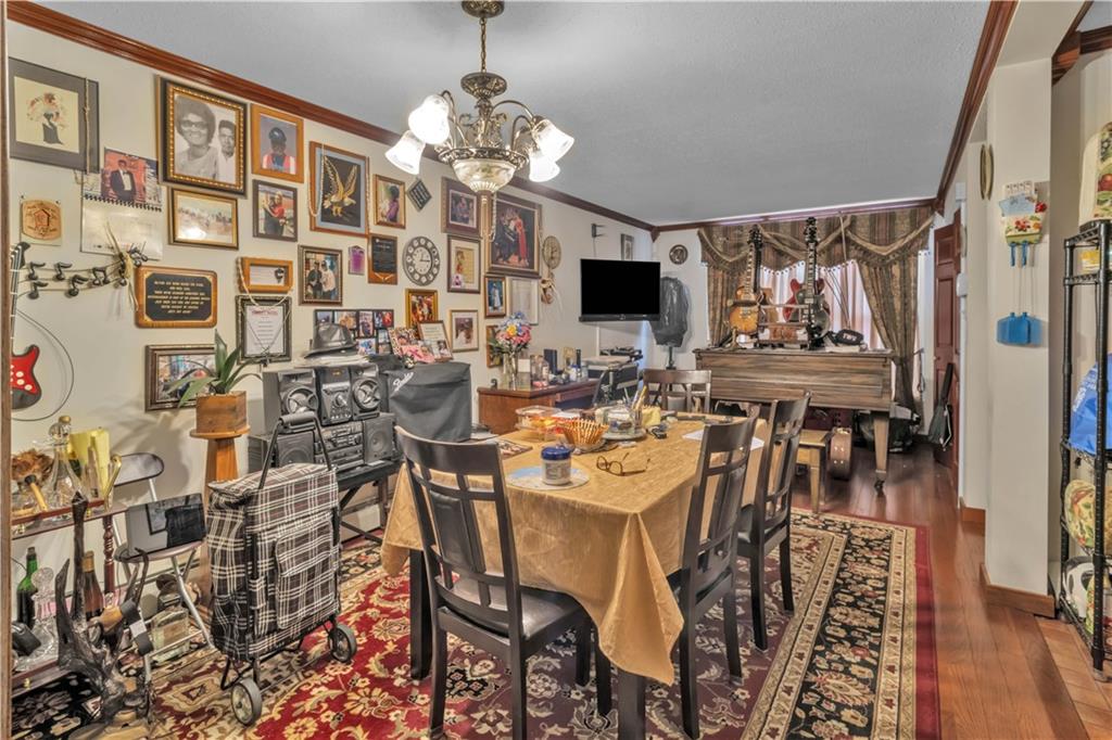221 MacDougal Street Brooklyn, NY 11233 - Photo 5 of 23 a view of a dining room with furniture and chandelier