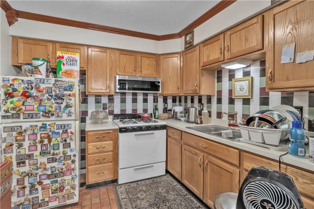221 MacDougal Street Brooklyn, NY 11233 - Photo 6 of 23 a kitchen with stainless steel appliances a sink stove and cabinets