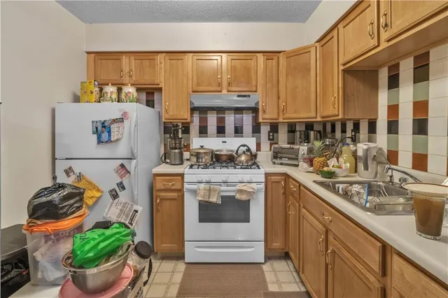 a kitchen with stainless steel appliances granite countertop a stove and a sink