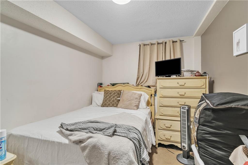 221 MacDougal Street Brooklyn, NY 11233 - Photo 9 of 23 a bedroom with a bed and a television