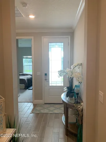 a hallway with a couch and chandelier