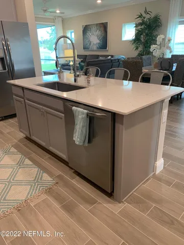 a view of living room with granite countertop furniture a fireplace and potted plants