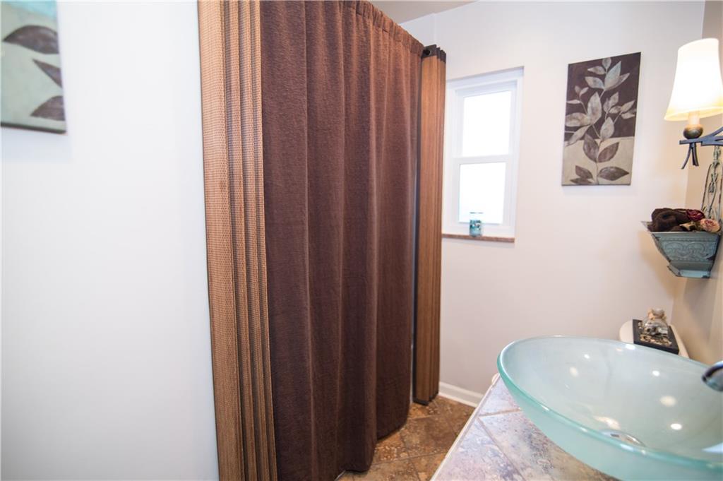 1032 Silver Lane McKees Rocks, PA 15136 - Photo 13 of 21 The full bath includes a tiled vanity with a bowl sink.