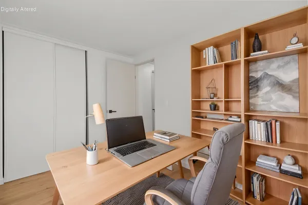 a bedroom with a bed and a painting on the wall
