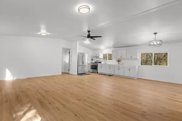 a view of a small house with backyard