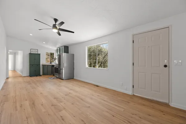 a living room with furniture a rug and a window