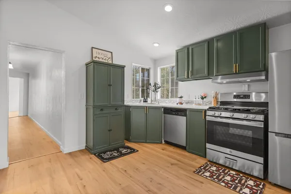 a bedroom with a bed and a potted plant on the dresser