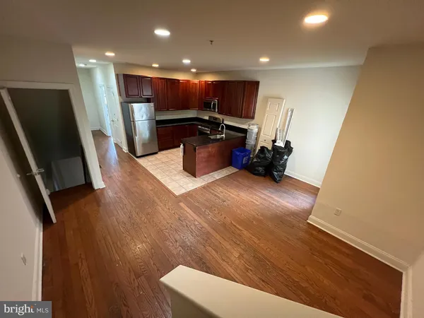 a kitchen with a sink stainless steel appliances a refrigerator and a stove top oven