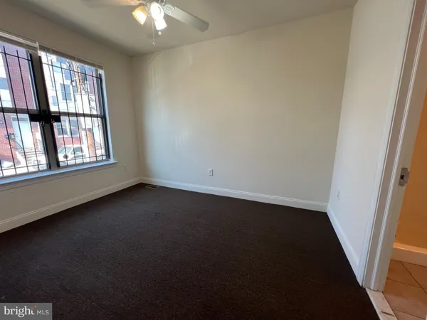 an empty room with windows and entrance