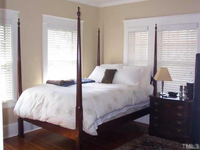 1708 Dare Street Raleigh, NC 27608 - Photo 7 of 9 a bedroom with a bed and a window