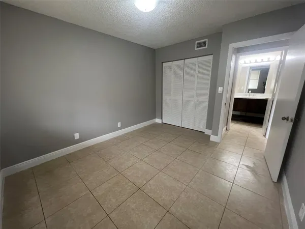 a view of an empty room and a bathroom