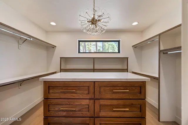 a view of empty room with wooden floor and fireplace