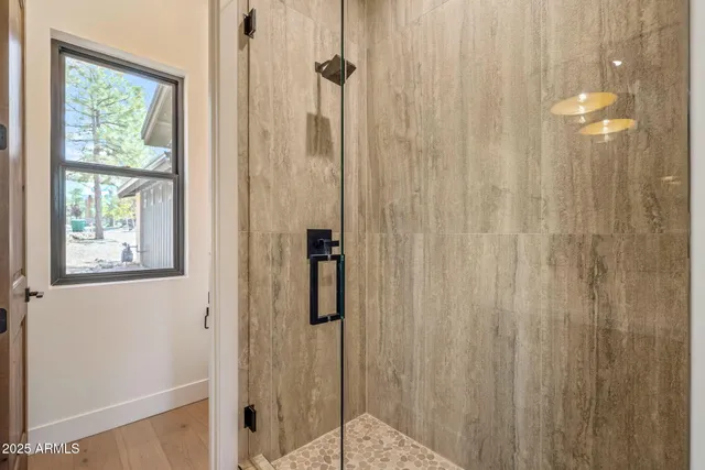 a view of empty room with fireplace and wooden floor