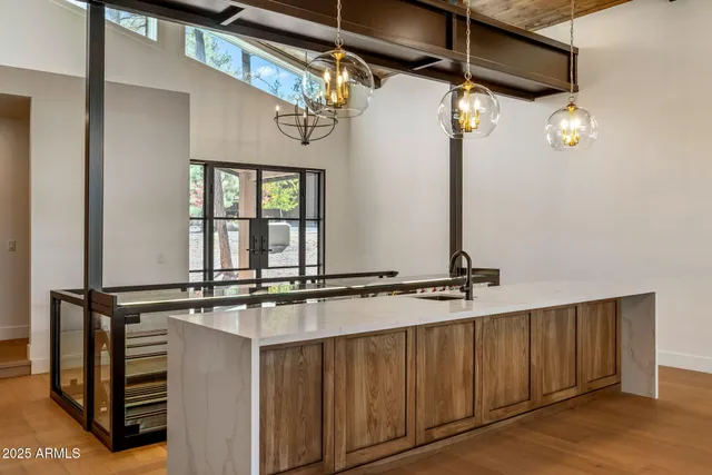 a large kitchen with a large window a counter space and stainless steel appliances