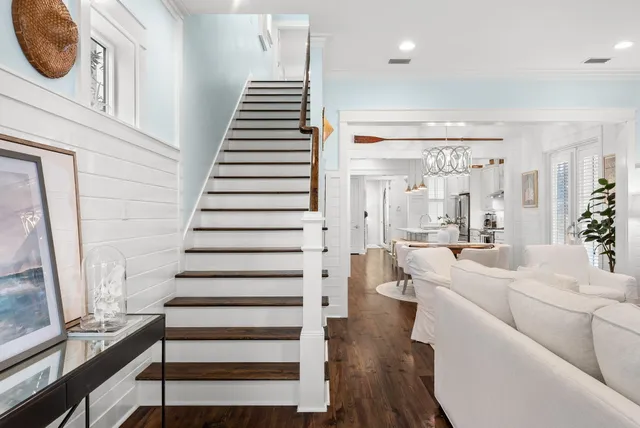 a bedroom with a bed and a table with wooden floor