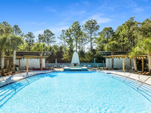 an aerial view of residential houses with yard and mountain view in back