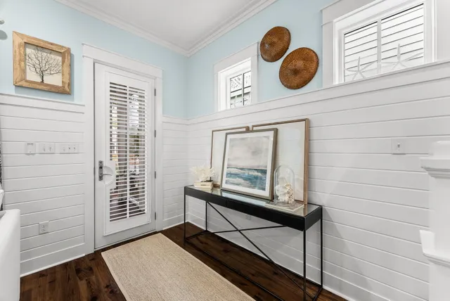 a living room with furniture a flat screen tv and a large window
