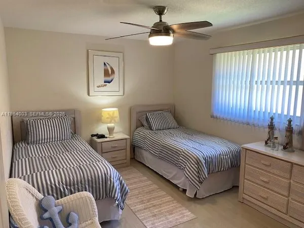 a bedroom with bed and a window