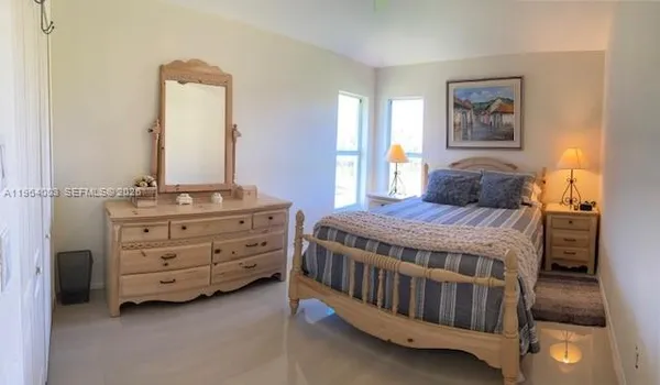 a bedroom with a bed and a dresser