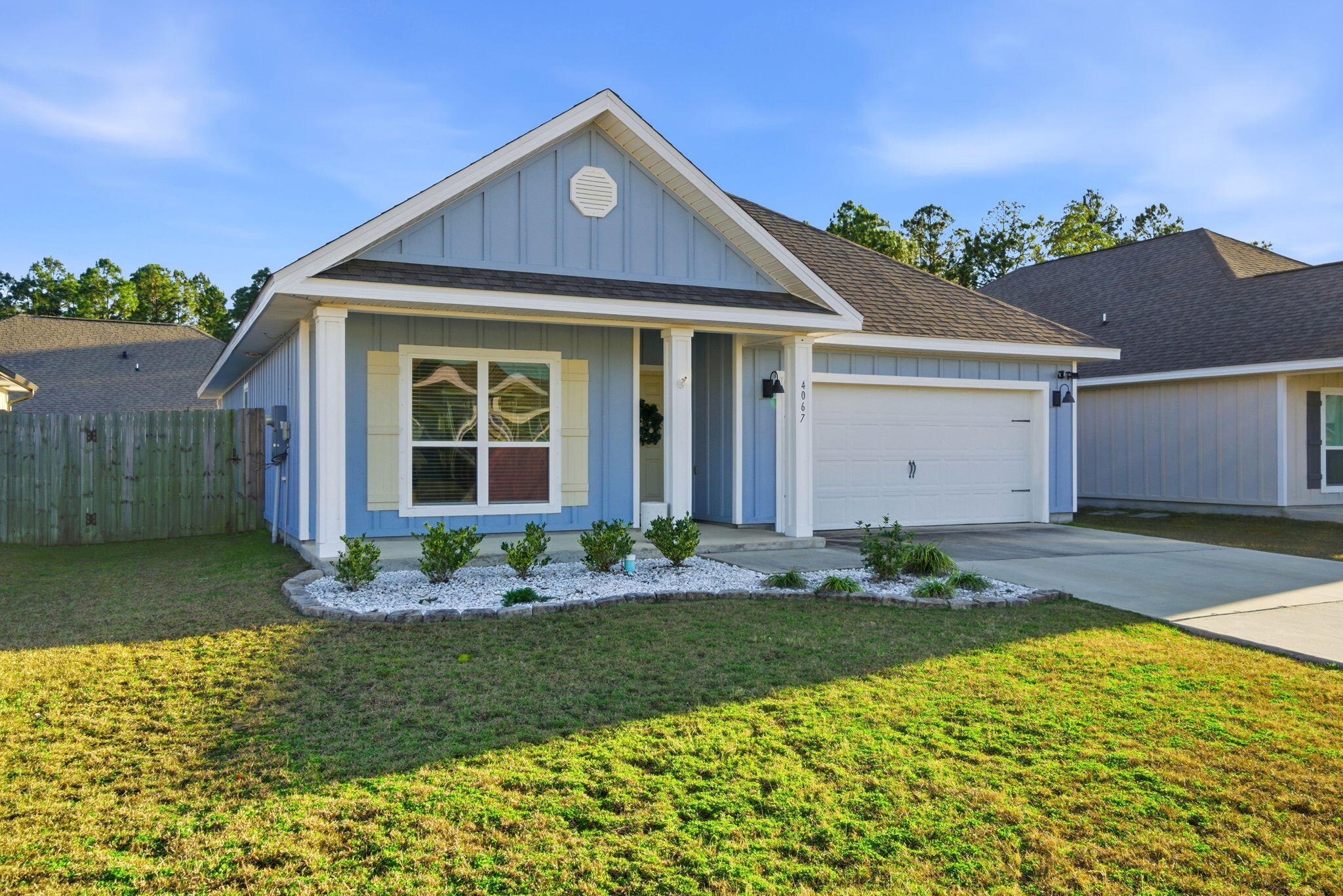 4067 Blaney Lane Pace, FL 32571 - Photo 2 of 40 a front view of a house with garden