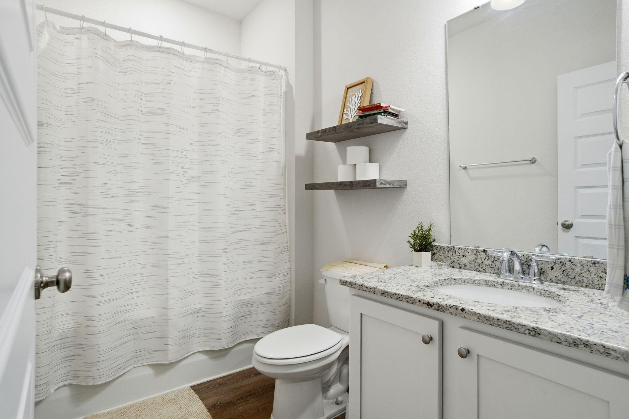 4067 Blaney Lane Pace, FL 32571 - Photo 33 of 40 a bathroom with a granite countertop sink toilet and a mirror