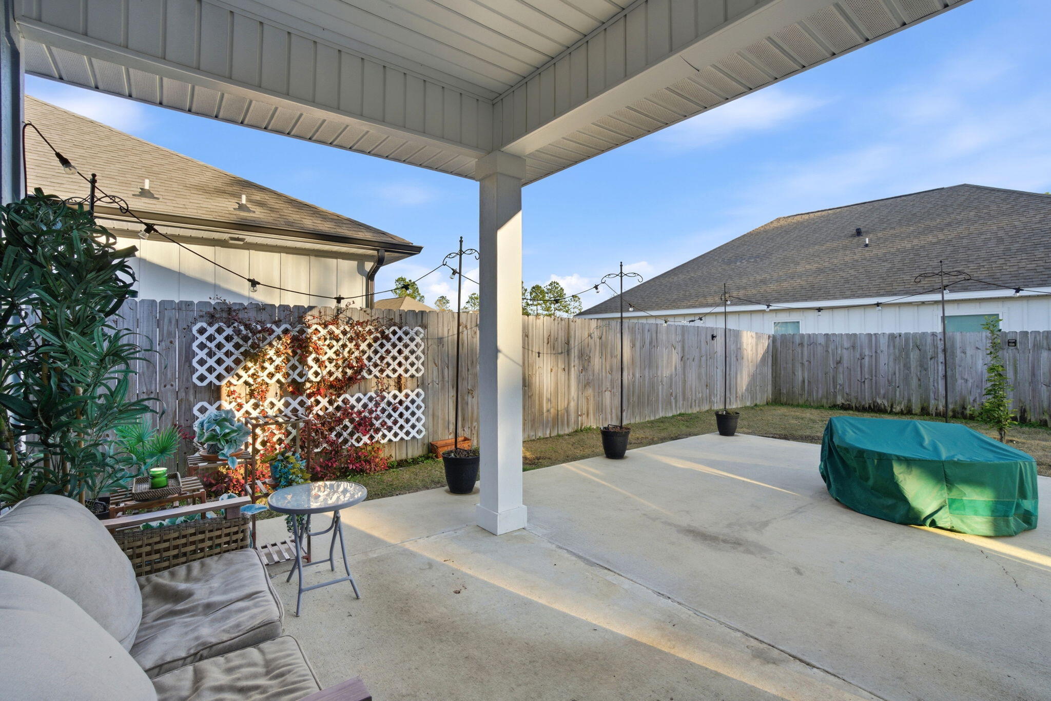 4067 Blaney Lane Pace, FL 32571 - Photo 35 of 40 a view of a patio with a table and chairs and potted plants