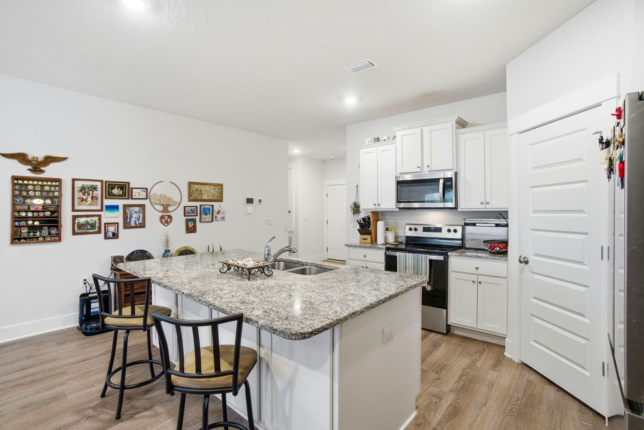 4067 Blaney Lane Pace, FL 32571 - Photo 7 of 40 a kitchen that has a table chairs and wooden floor