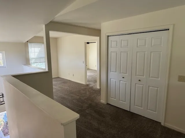 a view of small space with wooden floor and windows