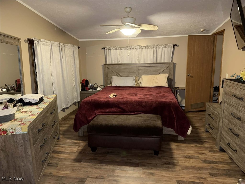 56 3rd Street Rayland, OH 43943 - Photo 32 of 46 Bedroom featuring ornamental molding, dark wood-style flooring, and a ceiling fan