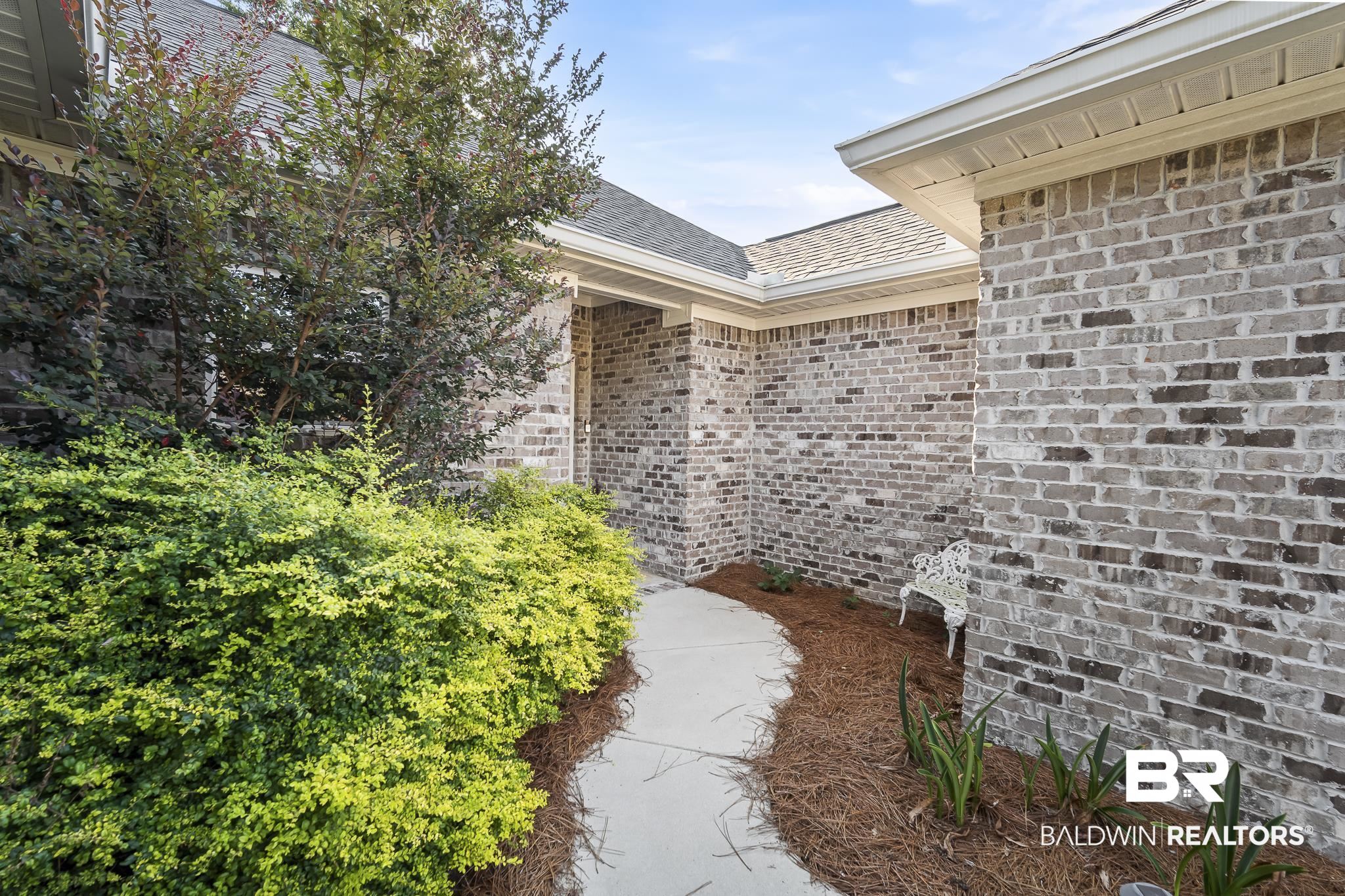 113 Timberline Drive Daphne, AL 36526 - Photo 3 of 44 Property entrance featuring brick siding, a patio, and roof with shingles