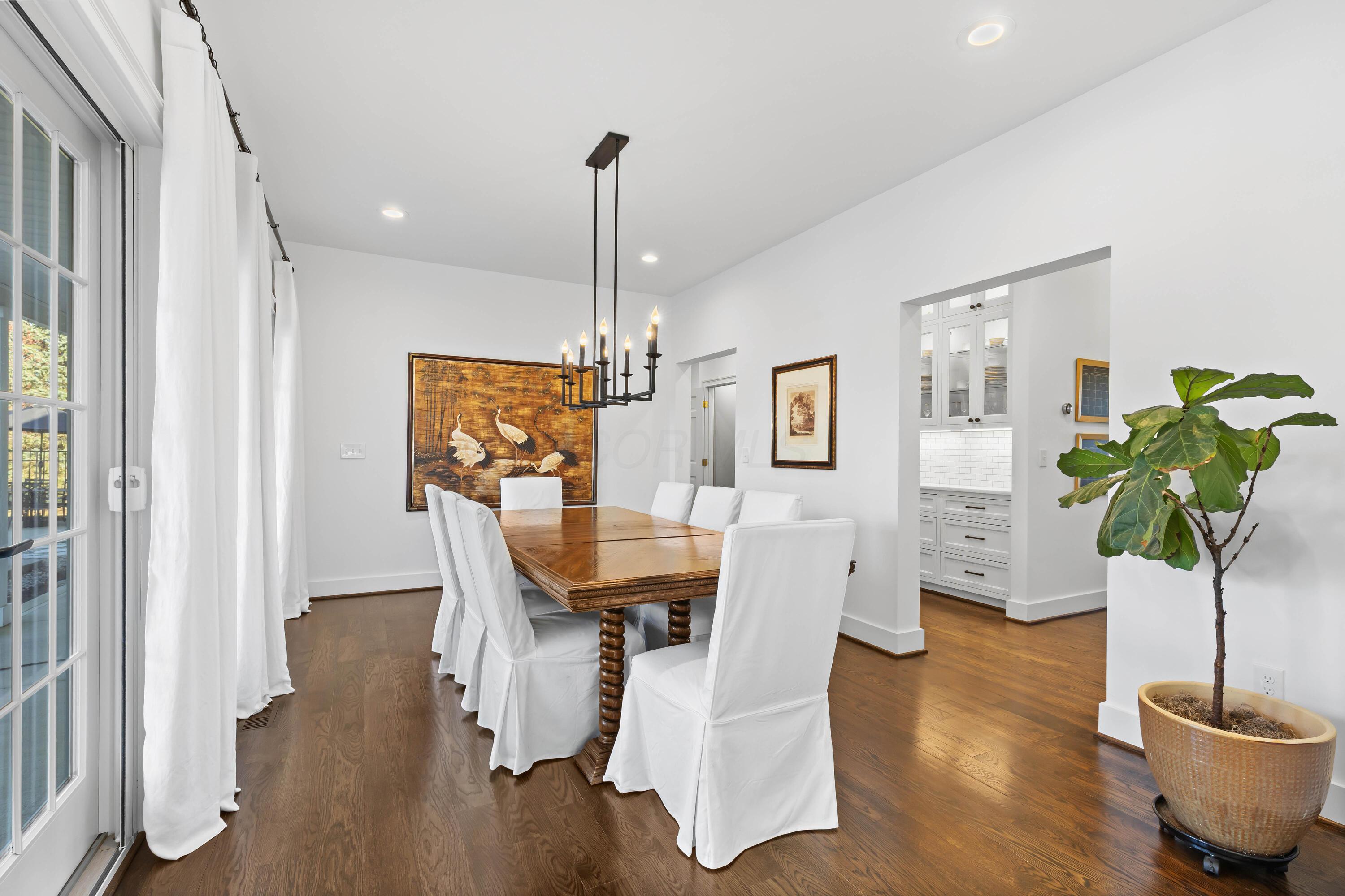 1364 Dale Ford Road Delaware, OH 43015 - Photo 21 of 112 • Hardwood flooring • White painted walls • Chandelier • Can lighting • (2) sets of french doors to covered patio