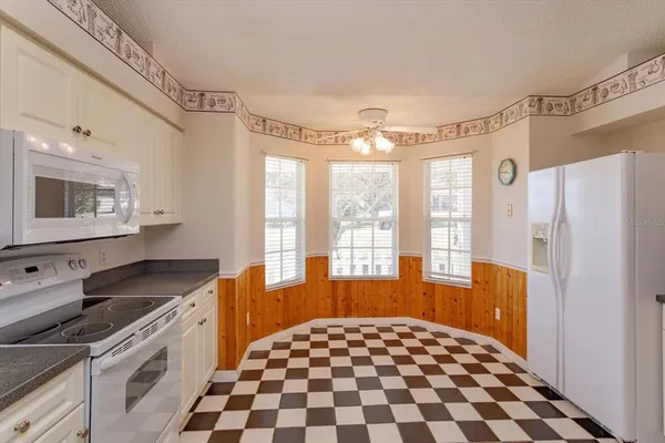 a kitchen with a refrigerator a sink and a window