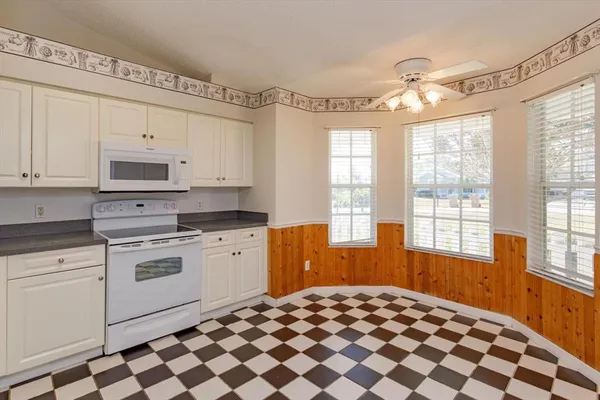 a kitchen with a stove a sink and a window