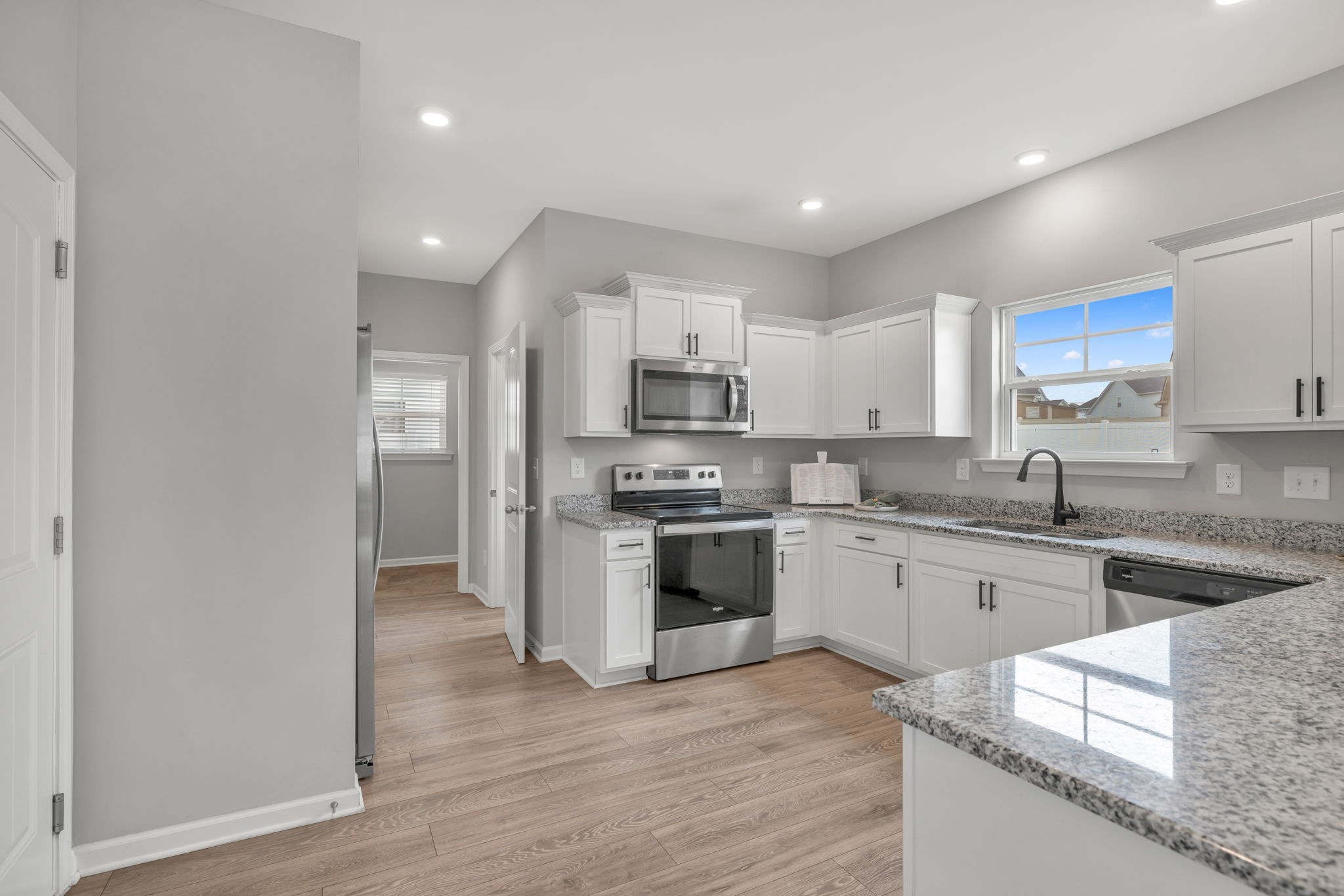 312 Turney Lane Spring Hill, TN 37174 - Photo 22 of 52 a kitchen with granite countertop a stove top oven sink and cabinets