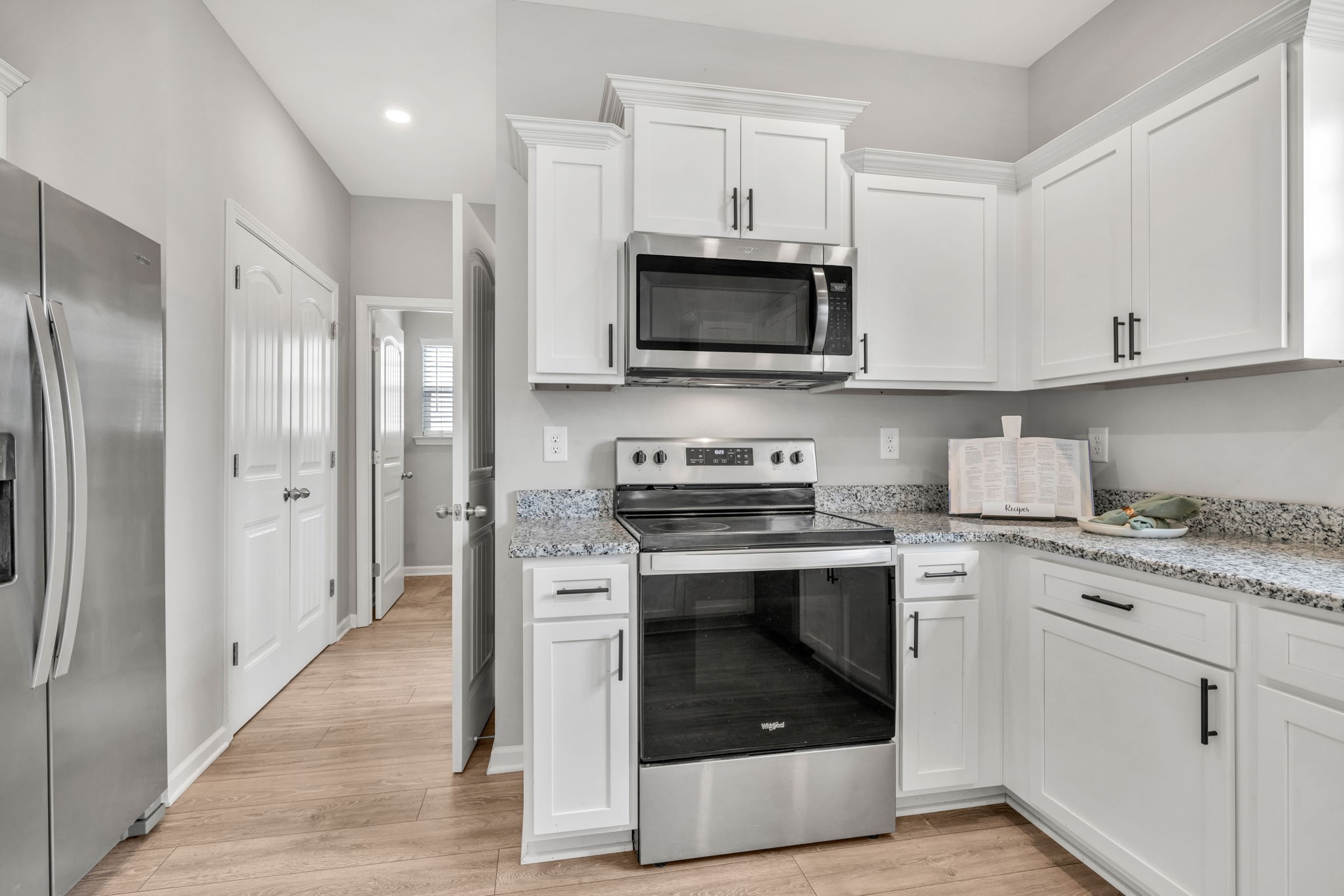 312 Turney Lane Spring Hill, TN 37174 - Photo 26 of 52 a kitchen with stainless steel appliances granite countertop a stove a refrigerator and a microwave