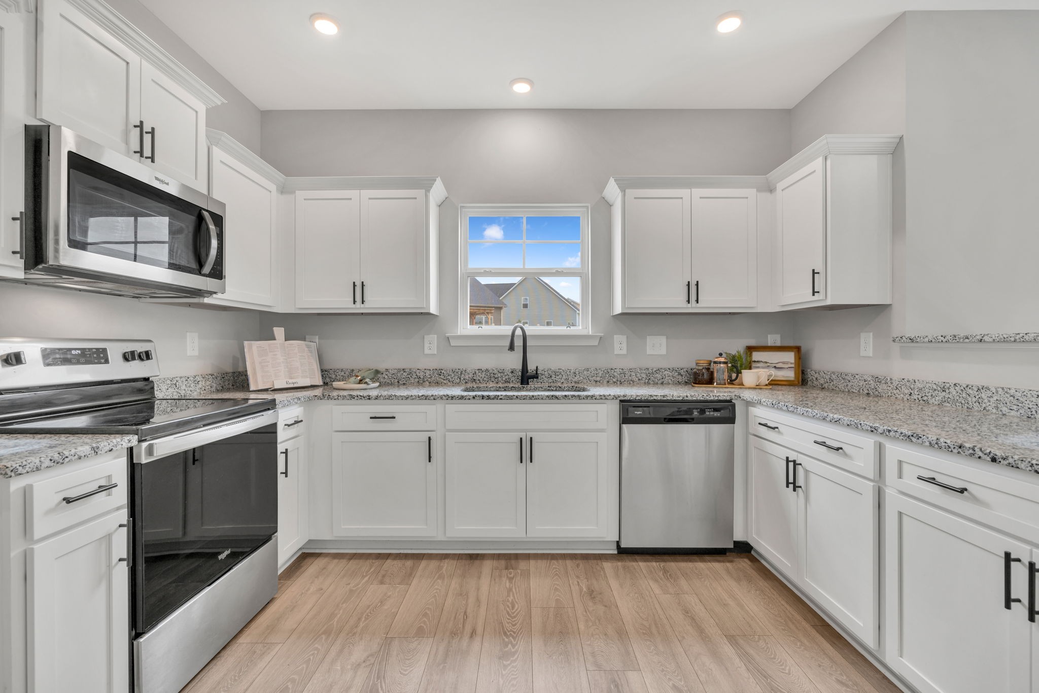 312 Turney Lane Spring Hill, TN 37174 - Photo 28 of 52 a kitchen with granite countertop cabinets stainless steel appliances a sink and wooden floor