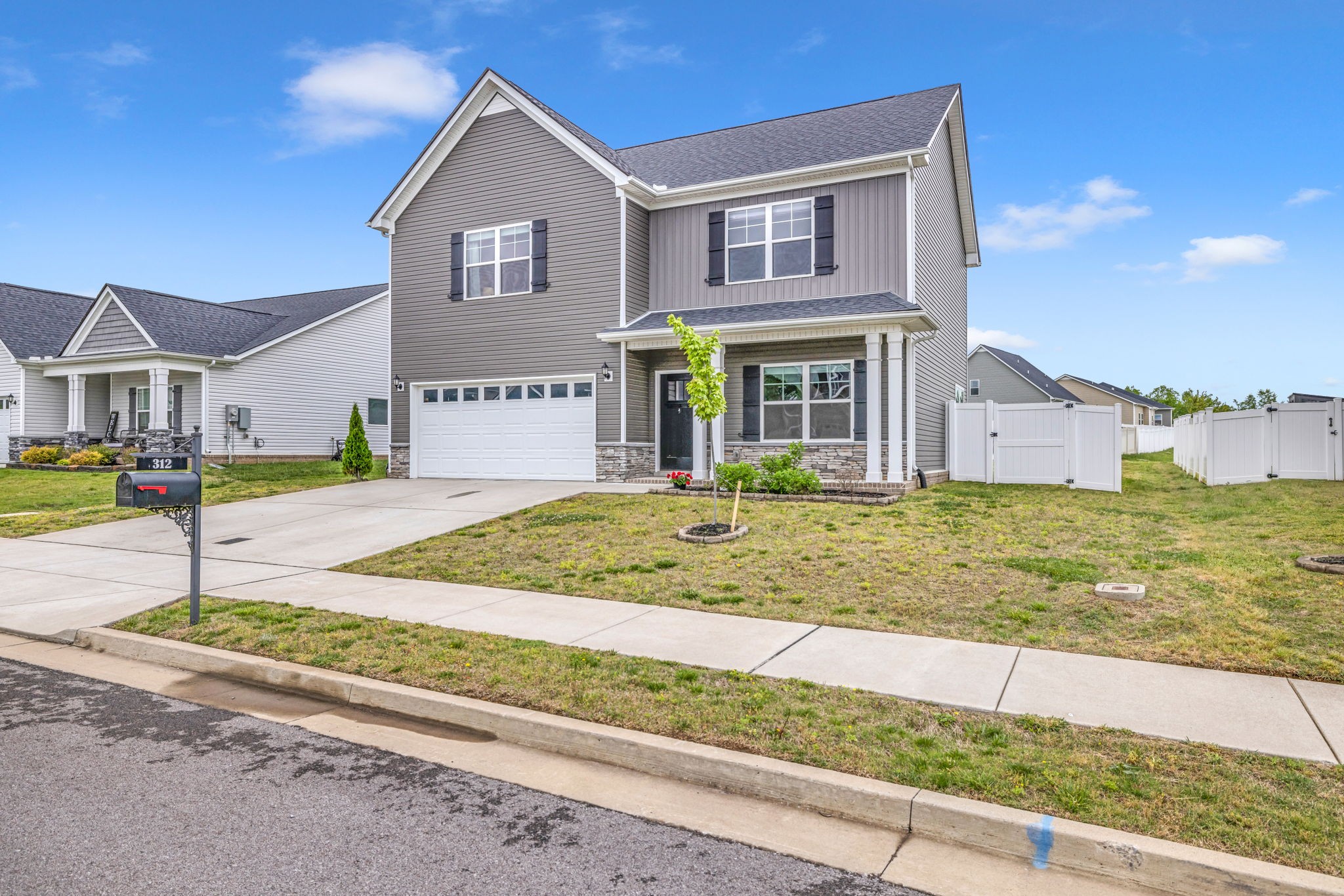 312 Turney Lane Spring Hill, TN 37174 - Photo 5 of 52 a front view of a house with garden
