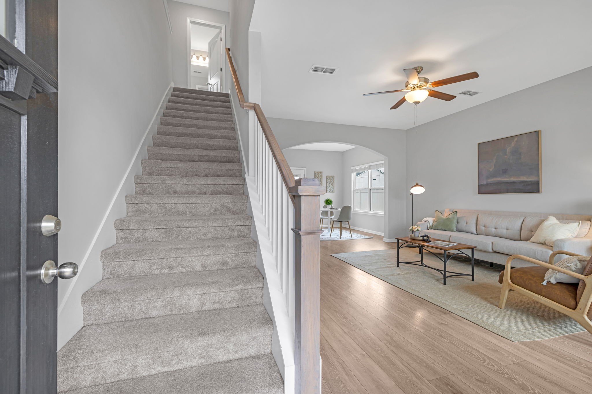 312 Turney Lane Spring Hill, TN 37174 - Photo 7 of 52 a living room with couches and a potted plant on a bookshelf with wooden floor