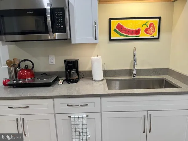 a kitchen with a refrigerator a sink and a stove