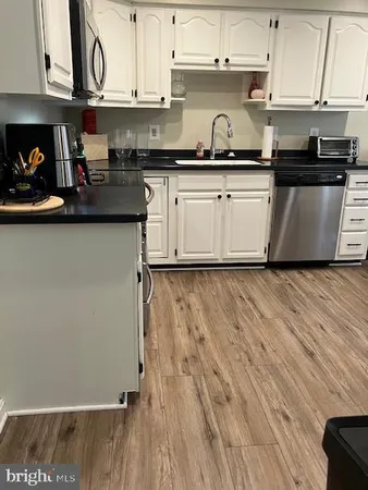 a kitchen with stainless steel appliances granite countertop a sink and cabinets