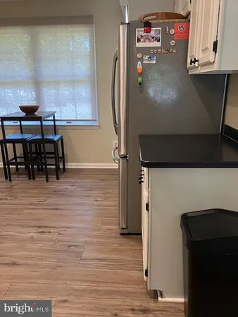 a view of a workspace room with wooden floor and windows