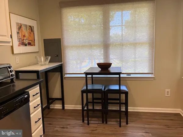 a view of a dining room with furniture and window