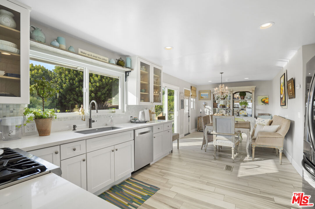 6363 Zumirez Drive Malibu, CA 90265 - Photo 11 of 34 a large white kitchen with a large window
