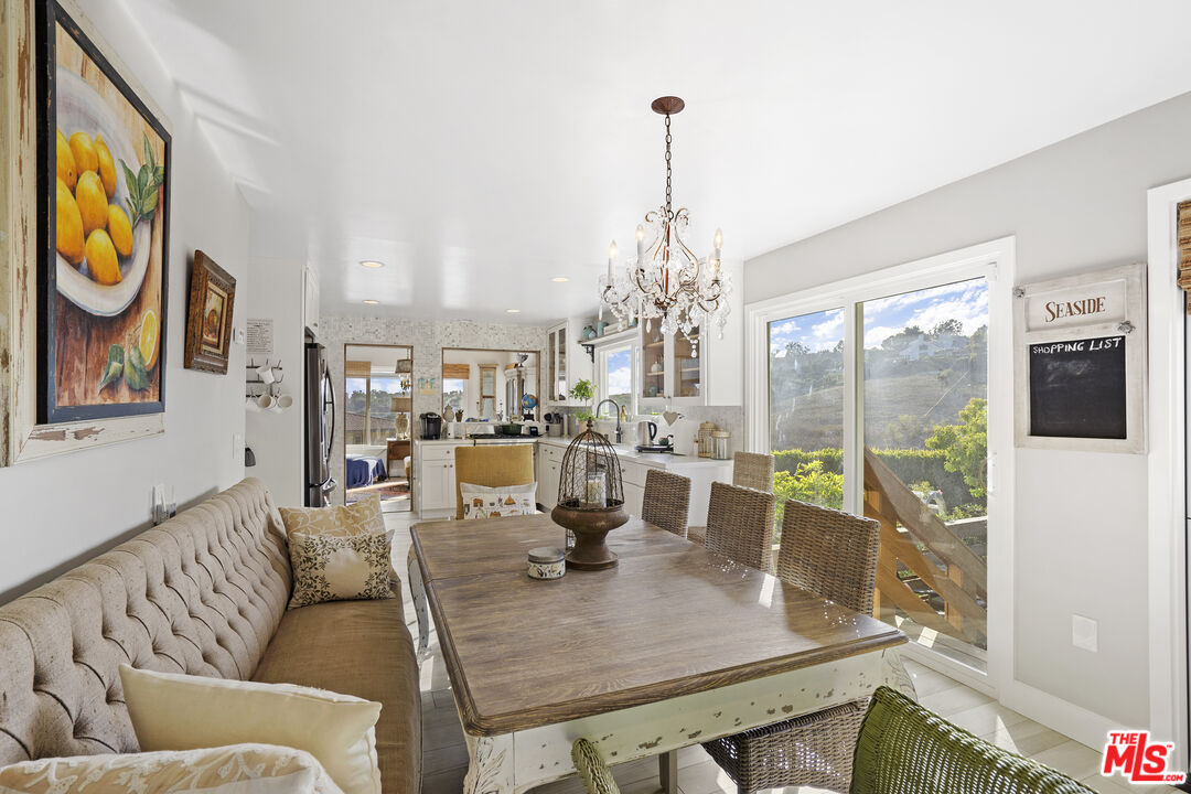 6363 Zumirez Drive Malibu, CA 90265 - Photo 12 of 34 a living room with furniture and a floor to ceiling window